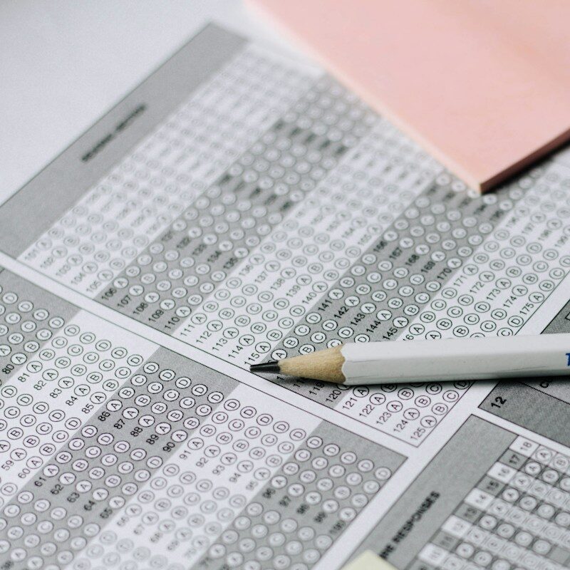 gray and white click pen on white printer paper